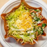 Taco Salad · Chicken, ground beef or chicken, beans, cheese, lettuce, sour cream, guacamole and pico de g...