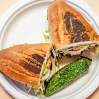 Chicken Torta · With lettuce, guacamole, tomatoes, onions and beans.