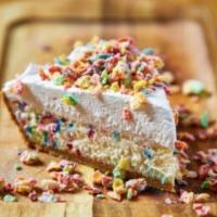 Fruity Pebbles Cheesecake · Funfetti cheesecake in a graham cracker crust topped with whipped cream and glazed fruitty p...