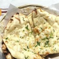 Garlic Naan · Clay oven leavened bread with garlic and herbs.