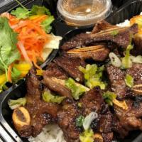 *C11. Com Trung Suon Bo Dai Hahn · Charbroiled Korean style beef short ribs, over easy egg, steamed rice, side salad