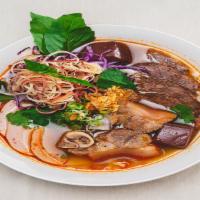 Bun Bo Hue · Vietnamese Spicy Soup
Thicker rice noodle in the flavor of spicy, salty lemongrass soup. Top...