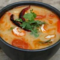 Tom Yum Soup · classic Thai hot & sour soup flavored with Thai chili and lime juice and accompanied with on...