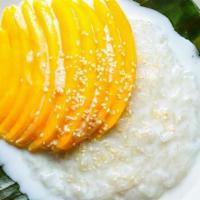 Mango With Coconut Rice Pudding · Our take on a classic!  Ripe mango slices served over sweet coconut rice pudding.