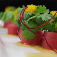 Tataki Tuna Special Roll · Shrimp tempura, avocado, cucumber and masago topped with seared tuna and spicy sauce.