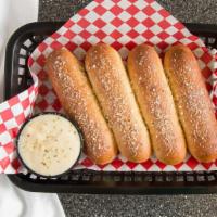 Garlic Breadsticks · Four warm, melt-in-your-mouth breadsticks served with hearty alfredo sauce for dipping.