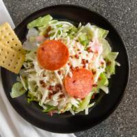 Shoppe House Salad · Crisp green salad with bacon bits, mozzarella and two slices of pepperoni. All salads are pr...
