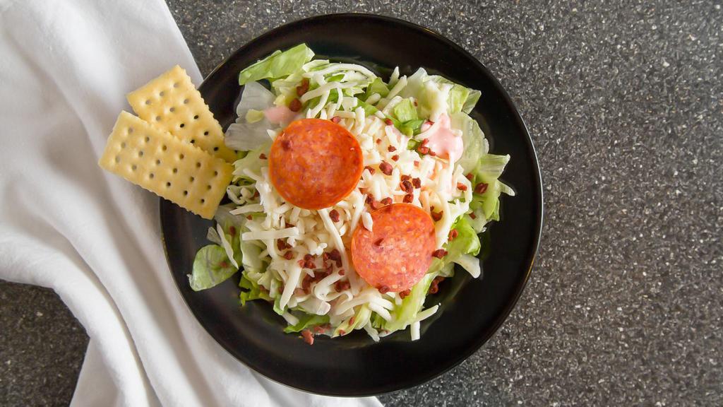 Shoppe House Salad · Crisp green salad with bacon bits, mozzarella and two slices of pepperoni. All salads are prepared with dressing on the side.
