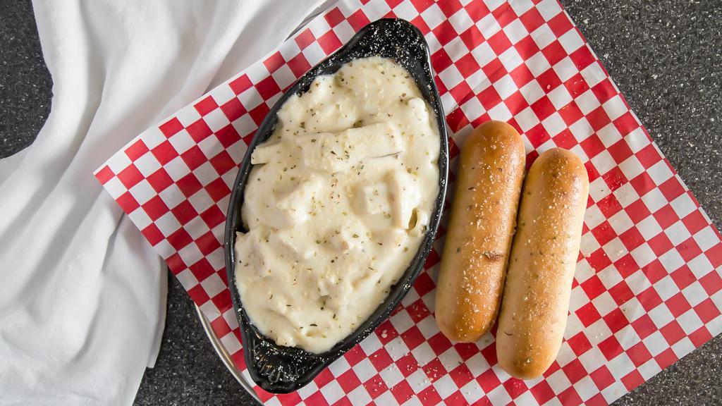 Chicken Fettuccini Alfredo · Fettuccini noodles tossed with Alfredo sauce, sliced grilled chicken and Parmesan cheese, served with 2 breadsticks.