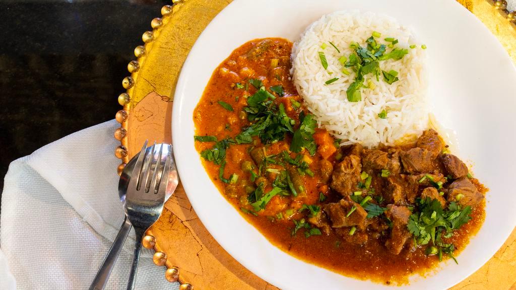 Lamb Curry · Served with basmati rice with the option to add vegetables and Indian bread.
