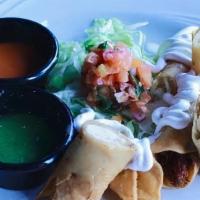 Taquitos · 3 Flash-fried corn tortilla tacos filled with chicken or potato. Topped with lettuce, sour c...