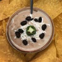 Bean Dip With Mozzarella · Refried black beans mixed with mozzarella cheese served with homemade tortilla chips.