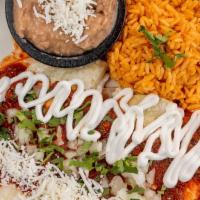 Enchiladas Rojas (Red) · Tomato and guajillo pepper sauce, with chicken, sour cream and fresco cheese. Side of rice a...