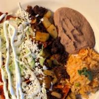 Enchiladas Leoneras · Topped with a guajillo pepper sauce, chorizo, potatoes, sour cream, fresco cheese and lettuc...