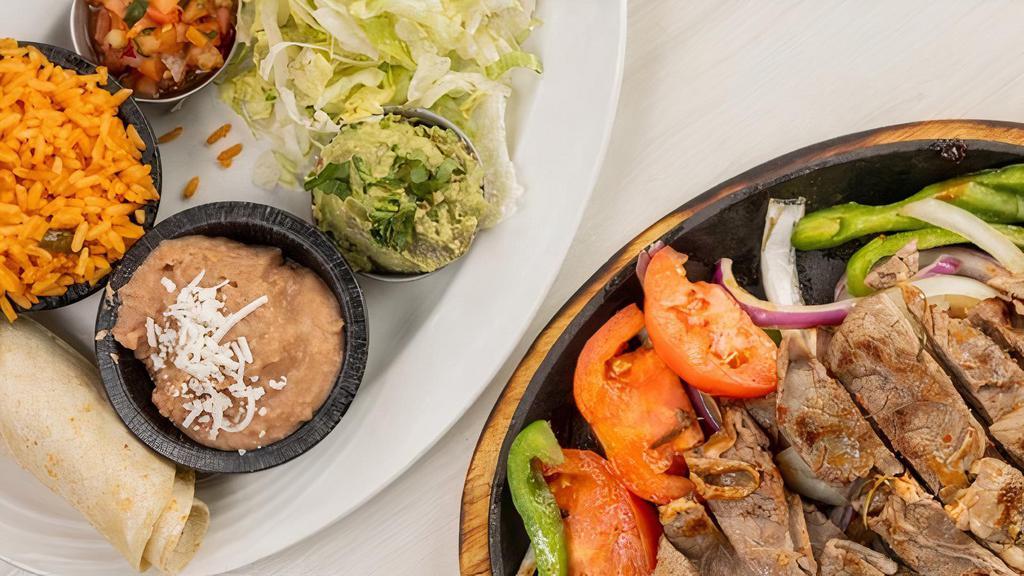 Rosemary Steak Fajitas · Sautéed Bell peppers, onions and tomatoes on a hot skillet. Served with lettuce, Pico de Gallo, guacamole, sour cream, rice, beans, corn or flour tortilla.