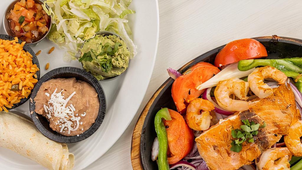 Seafood Combo Fajitas · Sautéed Bell peppers, onions and tomatoes on a hot skillet. Served with lettuce, Pico de Gallo, guacamole, sour cream, rice, beans, corn or flour tortilla.