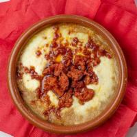 Queso Fundido Con Chorizo · Melted Mexican white cheese mixed with chorizo and a side of tortillas.