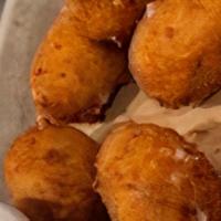 Texas Torpedoes · Smoked pork poppers filled with jalapeño and Provolone cheese, with chipotle ranch dressing.