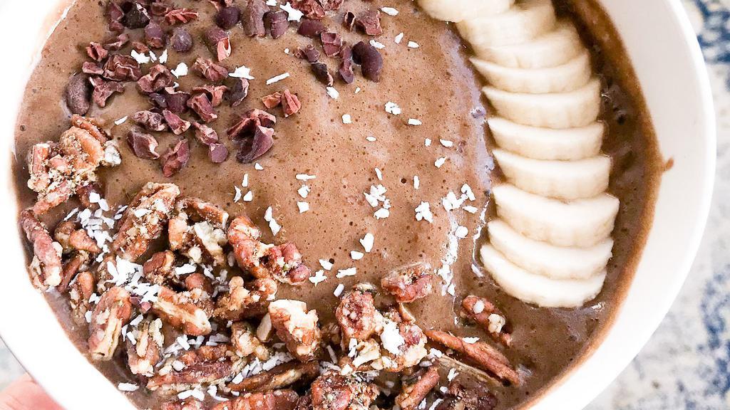 Chocolate Nicecream · In the bowl (all organic): Banana, Almond Milk, Chocolate Protein Powder (vegan, GF), Cacao Powder, Vanilla..... On the top: Granola (GF), Coconut Flakes, Banana, Cacao Nibs