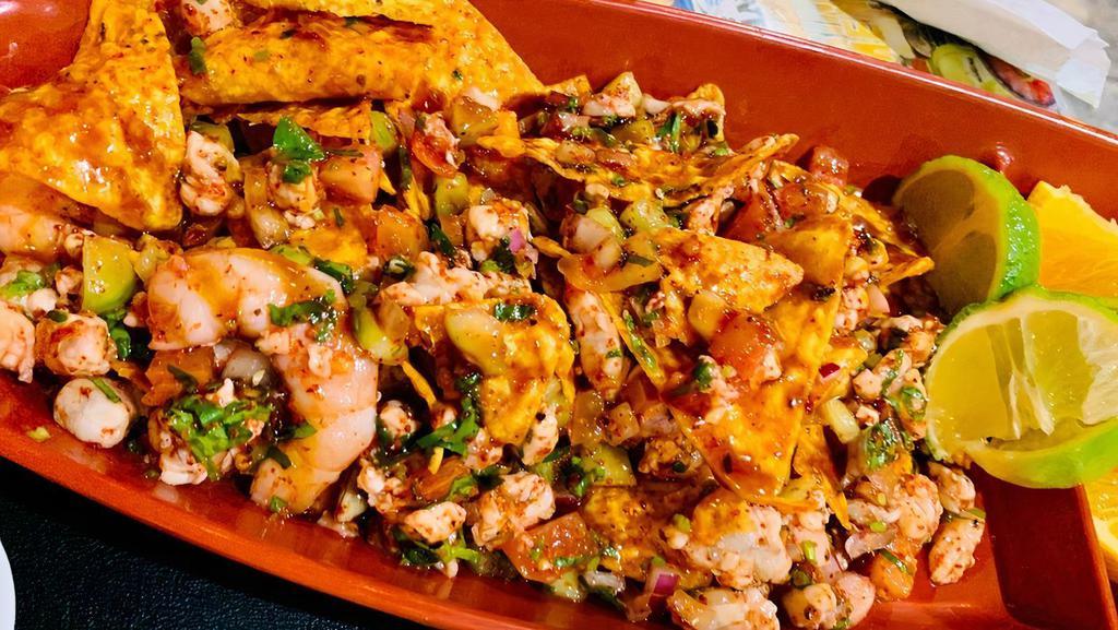 Don Ceviche · Shrimp ceviche that is cooked in lime with whole cooked shrimp mixed in Dorito nachos.