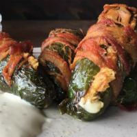 Wrapped Jalapenos (4) · A Jalapeno stuffed with cheese wrapped with bacon
