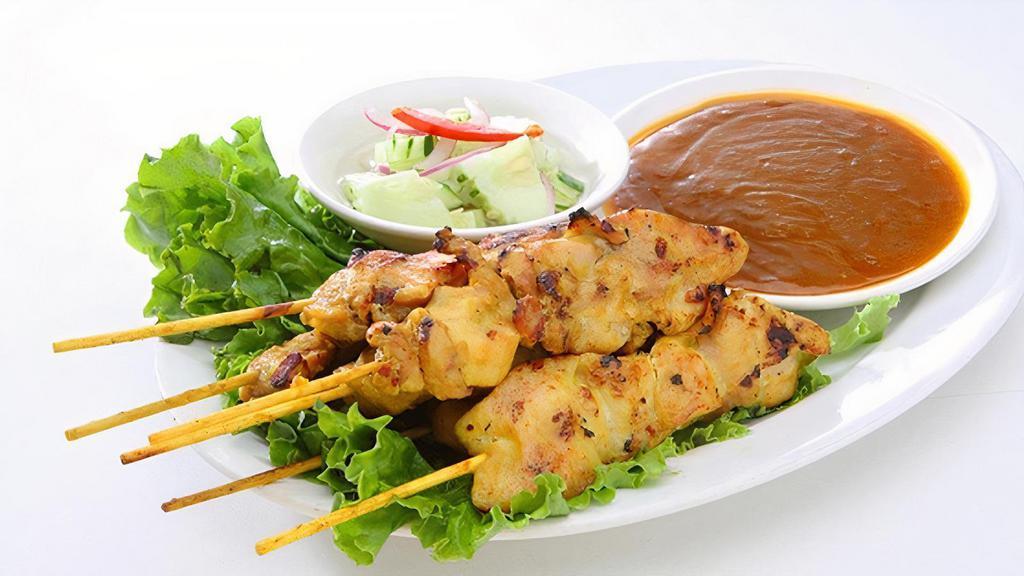 Satay (4) · Skewered marinated chicken or tofu in a mixture of thai spices. Served with peanut sauce and cucumber salad.
