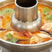 Tom Yum Soup · Lemongrass soup with tomato, onion, cilantro, and mushroom. Spiced with thai chili, kaffir l...