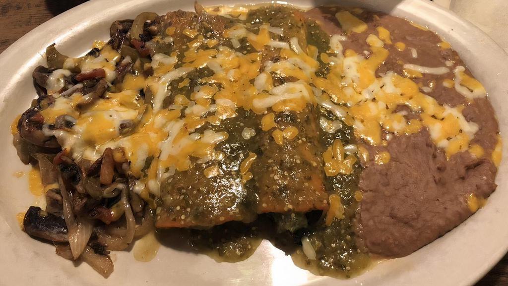 Enchiladas De Espinacas · Two spinach & cheese enchiladas topped with your choice of sour cream or green sauce. Served with two sides.