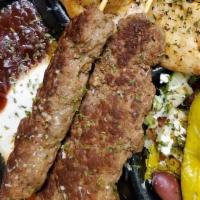 Combo Plate: Kufta Kabab With Fries And Baklava · 2 skewers kufta, pita bread, salad, tzatziki sauce, hot sauce, barbecue sauce.