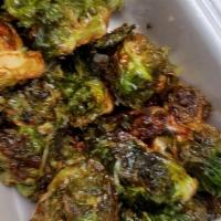 Brussels Sprouts · Fried brussel sprouts topped with cilantro, parmesan cheese and grapes.