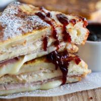 Monte Cristo Sandwich  · Ham & cheddar cheese on a french toast bread with cranberry cream sauce & choice of hash bro...