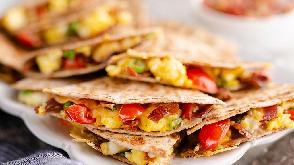 Breakfast Quesadilla · Two scrambled eggs, bacon, cheese, pico de gallo and salsa in a flour tortilla served with hash brown patty or tater tots.