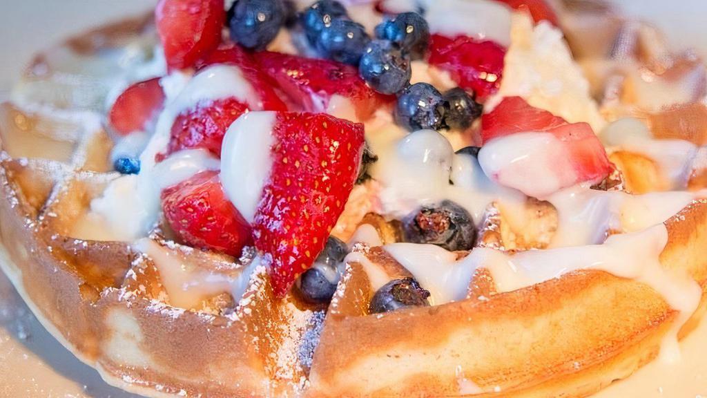 Belgian Waffle · Belgian Batter, Cream Cheese Anglaise, Powdered Sugar, House-made Whipped Cream, Fresh Berries & Warm Syrup