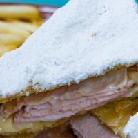 Monte Cristo · Brioche, Turkey, Duroc Ham, Swiss & Cheddar Flash Fried & Topped with Powdered Sugar Served ...