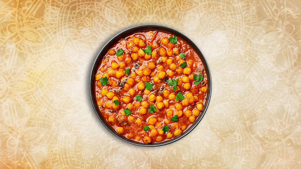 Tangy Chickpea Curry · Garbanzo beans cooked with tomatoes and a special blend of spices served with a side of aromatic basmati rice