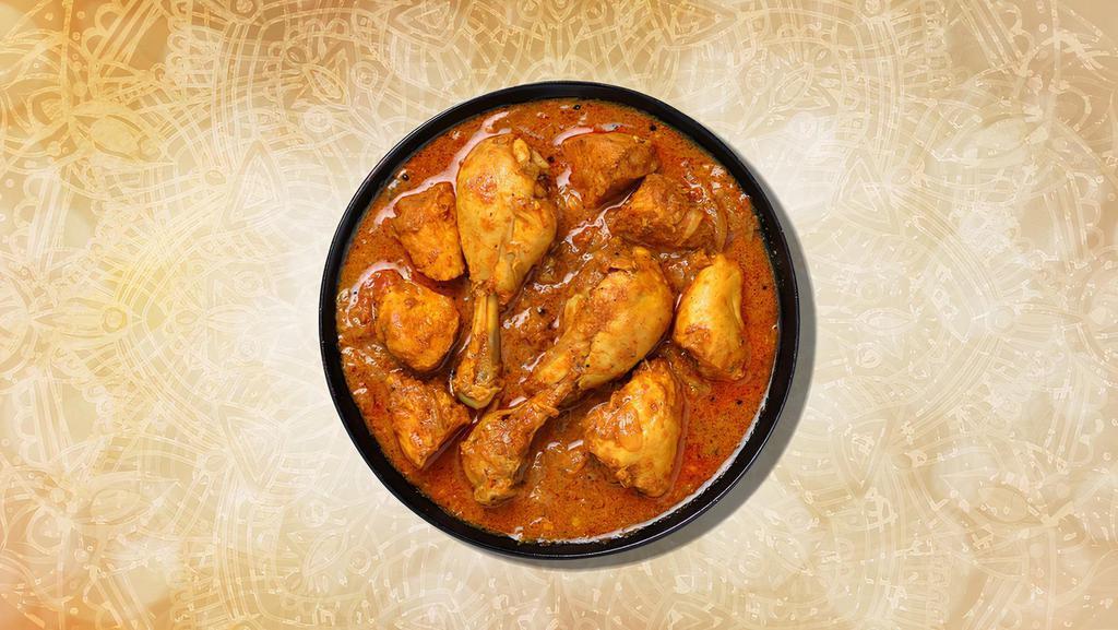 Chicken Curry · Chicken chunks sauteed with fresh garlic, ginger, and tomatoes served with a side of aromatic basmati rice