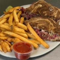 Reuben · Corned beef piled high on marble rye, with sauerkraut, Swiss cheese and thousand island dres...