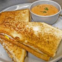 Grilled Cheese · American and mozzarella cheese, tomatoes, bacon and diced potatoes. Served on extra large wh...
