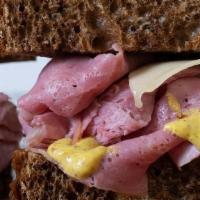 Corned Beef Rye · Corned beef, swiss, spicy mustard or russian dressing, on sliced marbled rye served hot or c...
