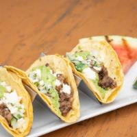Barbacoa Beef Tacos · Corn tortillas, onion, cilantro, salsa Verde, Queso fresco.  Served with a wedge of grilled ...