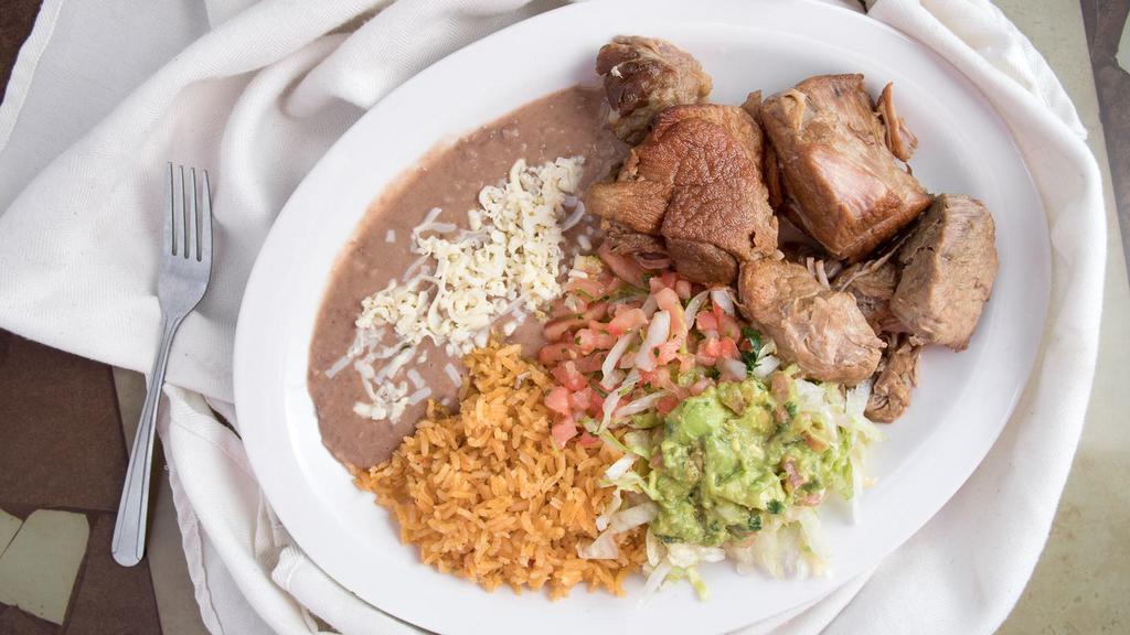 #36. Carnitas · Delicious roasted pork tips. Served with Mexican rice, refried beans, pico de gallo guacamole salad and flour tortillas.