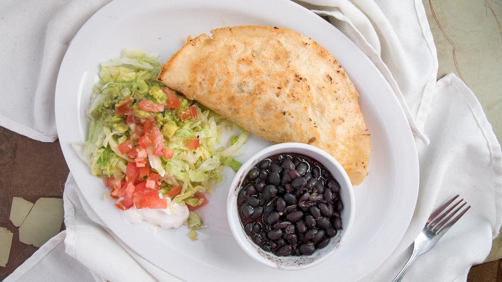 Quesadilla Mexicana · A grilled flour tortilla, spread with refried beans, cheese, stuffed with beef tips.