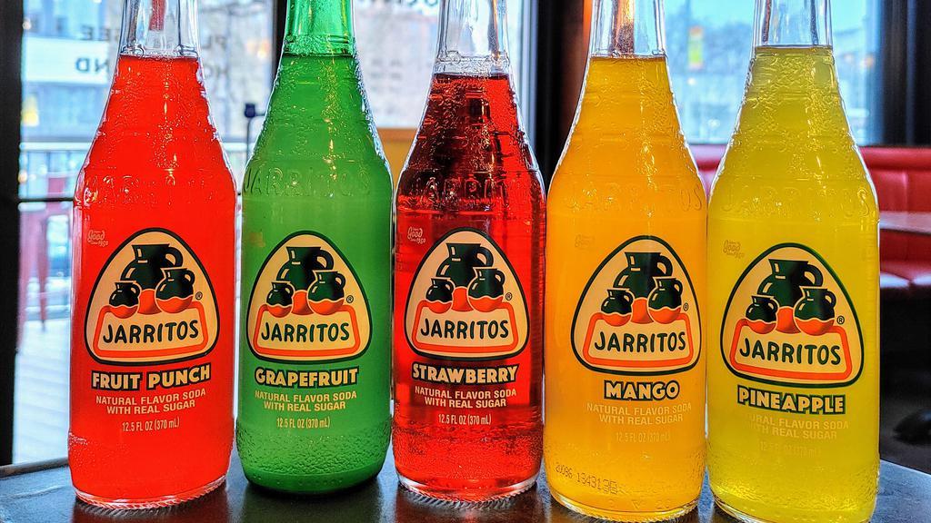 Jarritos · Assorted flavors of Jarritos bottled sodas.
