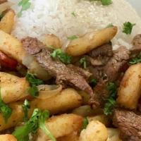Lomo Saltado Entrée · A traditional Peruvian dish that comes with pan-seared beef, tomatoes, onions + French Fries...