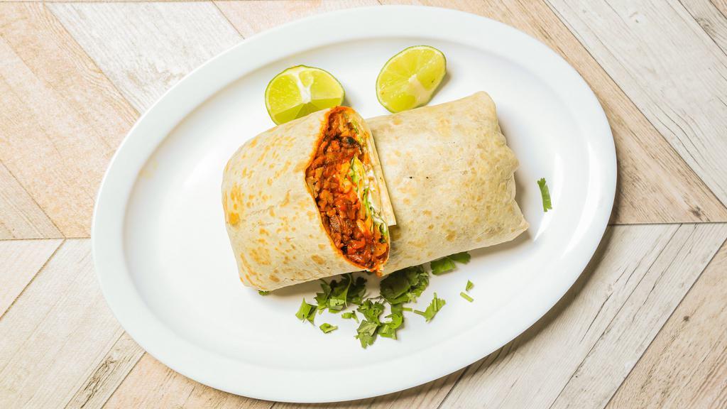 Burrito De Pastor · Marinated pork burrito all wrapped up with beans, cheese, lettuce, tomato, and sour cream.
