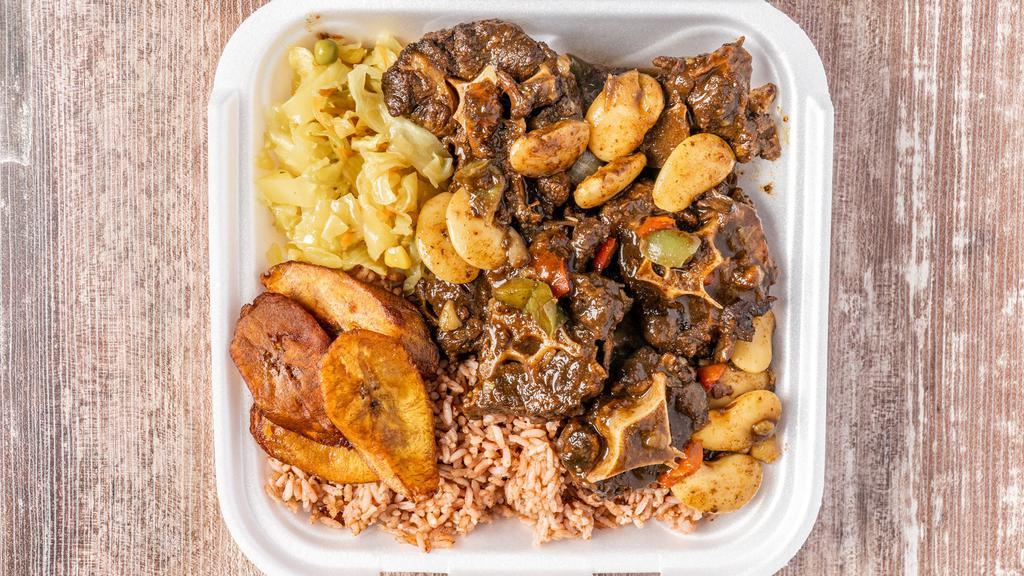Small Oxtail Bowl · Beef oxtail seasoned with natural herb and spice cooked tender and juicy, serve with rice and beans, sauteed  cabbage and fried plantain