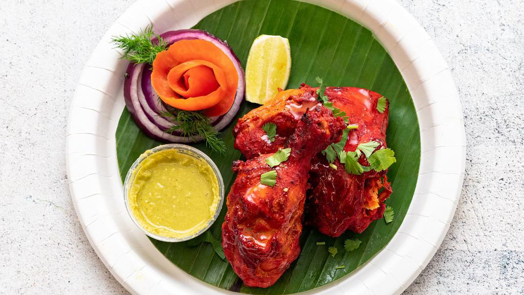 Tandoori Chicken · Chicken leg and thigh pieces are marinated overnight in yogurt with herbs and spices and cooked on skewers in a tandoor (clay oven).