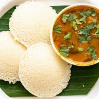 Idly With Sambar · Idli is a soft, pillowy steamed savory cake made from rice and lentil batter.
