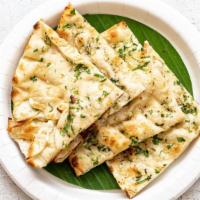 Garlic Naan · Garlic special. Bread baked in tandoor grill and topped with garlic.