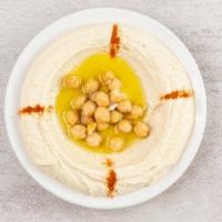 Hummus · A blend of ground chickpeas mixed with tahini, topped with olive oil & spices.